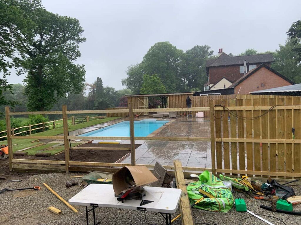 This is a photo of Bespoke custom fencing installed around a swimming pool by Fast Fix Fencing Gravesend